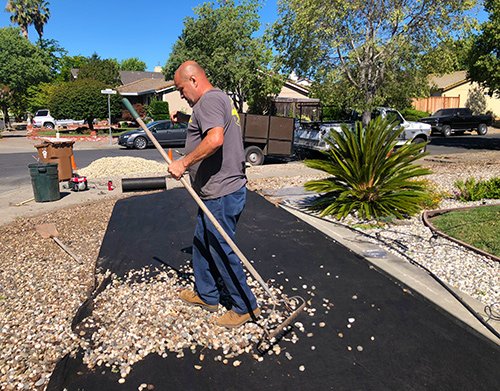 Now that weed block fabric is down we are moving the rocks in at a residential property in Napa