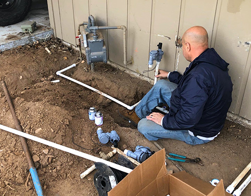 Robert, our irrigation expert, is building an irrigation valve manifold from scratch for a front yard project
